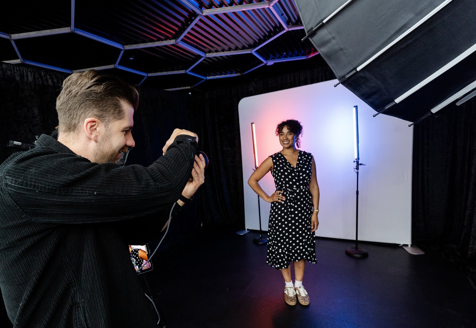 Photographer creating an event headshot station Houston setup with LED gradient lights